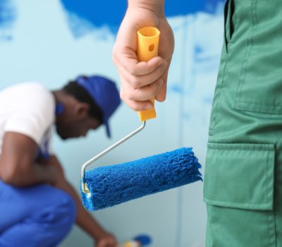 Male painters doing repair in room, closeup