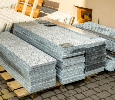 Piles of granite marble slabs.  Stone sheets for decorative construction.